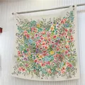 Detailed texture of vibrant floral silk scarf hanging on a minimalist striped wall - Off White