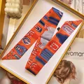 Detail of premium orange silk scarf with vintage geometric belt print in luxury gift box - Vibrant Orange Belt Buckle Style (S1860-9)