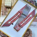 Detailed view of a pink and red twilly scarf with horsebit patterns in a gift box - 5*90cm / Deep Pink