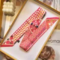 Pink silk twilly scarf with floral patterns in a yellow gift box with magazine backdrop - Peach Pink Geometric Floral (S1832-1)