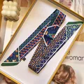 Detail of printed silk twilly scarf with geometric patterns in a yellow gift box - Navy Green Geometric Star (S1832-6)