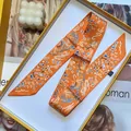 Narrow orange satin twilly scarf with blue abstract patterns in a gold-rimmed gift box - Orange (S932)