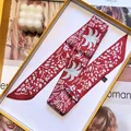 Macro shot of red printed floral twilly scarf in a gift box with fashion magazine - Rose Red (S932)
