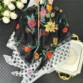 Detail of floral chiffon scarf with polka dot borders and elegant pearl accents - Color 3 (Black Floral/Polka Dot)