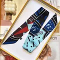 Elegant yellow and blue geometric silk twilly scarf displayed in a stylish gift box - Blue