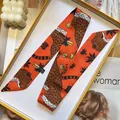 Detailed view of leopard print silk scarf in a premium gift box with fashion accessories - 95x5cm / Orange Red Leopard (S1835-3)