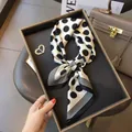 Detailed view of a vintage white silk scarf with black polka dots and striped edges - Black and White Polka Dots