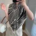 Elegant black and white geometric pattern silk scarf styled as a chic neck wrap for women - Black Beige