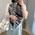 Elegant silk-like satin scarf with black and white stripes worn with a white vintage bag - Black