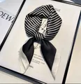 Elegant black and white striped satin square scarf styled with a classic French knot - Striped Black