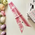 Detail of red and white Toile de Jouy silk twilly scarf with tiger print and floral decor - 100cmx6cm / Red