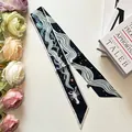 Double-sided slim silk scarf with navy lobster and sea wave patterns on white desk - Dark Green