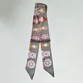 Detail of grey silk scarf featuring vintage Egyptian and robot illustrations for women - 80-100cm / Gray