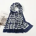 Detailed view of lightweight blue and white geometric pattern scarf with frayed edges - Navy Blue