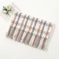 Detailed close-up of soft plaid scarf with fringe tassels and woven mosaic pattern - Grey White And Pink
