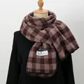 Detail of soft thick green plaid scarf with hemmed edges and woven brand label - Pink