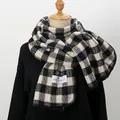 Detail of classic black and white plaid scarf with premium knit texture and woven brand label - Black