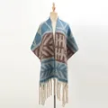 Detail of thick knit shawl with geometric patterns and long twisted tassels on a mannequin - Dark Cyan