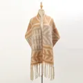 Thick knit shawl with geometric patterns and long tassels on a studio mannequin - Camel