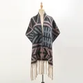 Detail of chunky knit shawl featuring geometric tribal patterns and thick cream fringes - Black and Pink