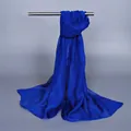 Elegant royal blue lightweight chiffon scarf hanging on a metal rack over dark grey background - 150x50cm / Sapphire Blue