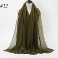 Army green crinkled cotton scarf with frayed edges draped on a studio mannequin - 180x90cm / Olive Green (#12)
