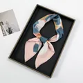 Close-up of artistic satin square scarf with abstract oil painting print on a tray - Pink Abstract