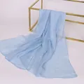 Elegant light blue sheer chiffon scarf draped over a gold metal frame on white background - 150x50cm / Blue Gray