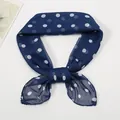 Detail of a navy blue chiffon scarf with white polka dots tied in a delicate bow knot - Navy Blue