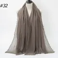 Solid dark khaki crinkled cotton shawl with frayed edges on a beige mannequin - 180x90cm / Taupe (32#)