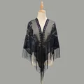 Close-up of black lace triangle shawl with floral cutout patterns and long fringe tassels - Navy Blue