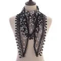 Detail of floral lace triangle scarf with black mesh fabric and delicate fringe trim - Black