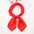 Detailed close-up of a vibrant red silk scarf tied in a knot on a white studio background - One Size / Red