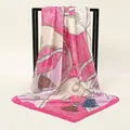 Detailed close-up of a 90cm printed silk scarf with paisley and chain patterns on a stand - 90*90cm / Magenta Beige Paisley (FJ587-04)