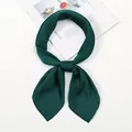 Close-up of a dark green satin scarf tied in a neat knot on an aesthetic magazine - One Size / Dark Green