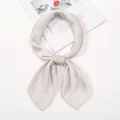 Elegant champagne satin silk neckerchief tied in a knot on minimalist magazine - One Size / Light Gray