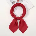 Detailed view of a bright red silk scarf tied in a bow on a stylish magazine background - One Size / Burgundy
