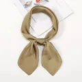 Detail of a khaki satin neck scarf tied in a bow on a white background with a magazine - One Size / Champagne