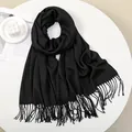 Detailed view of black cashmere feel scarf with soft fringe edges and elegant texture - 180-70cm / Black