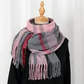 Detail of pink and grey plaid scarf with fringes on a mannequin for winter warmth - Pink Gray