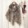 Detail of soft breathable spring scarf with vintage branch pattern on light fabric - Khaki