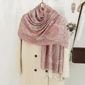 Classic paisley pattern scarf with tassels draped over a warm coat for a stylish winter look - Red & White