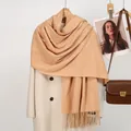 Detailed texture of beige fringe scarf with subtle grid pattern on white wool coat - 188x70cm / Camel