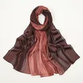 Detail of soft pleated satin scarf with elegant brown to pink gradient color - Red+Wine Red