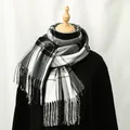 Classic black and white plaid cashmere-like scarf with fringe on a wooden mannequin - Black