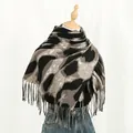 Detail of soft leopard print cashmere scarf with fringe tassels on mannequin - Khaki Leopard