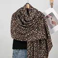 Classic thick leopard print scarf draped over a black sweater and blue jeans - Style 2 Small Leopard