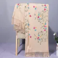 Detail of beige cashmere shawl showing floral vine embroidery and fringe tassels - 190x75cm / Camel