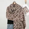 Close-up detail of leopard print cashmere scarf with natural frayed edges on wooden hanger - Dark Khaki Gray Style 3