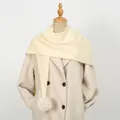 Detail of cream white knitted scarf featuring soft decorative pom-poms on the edge - 86*36cm / Beige
